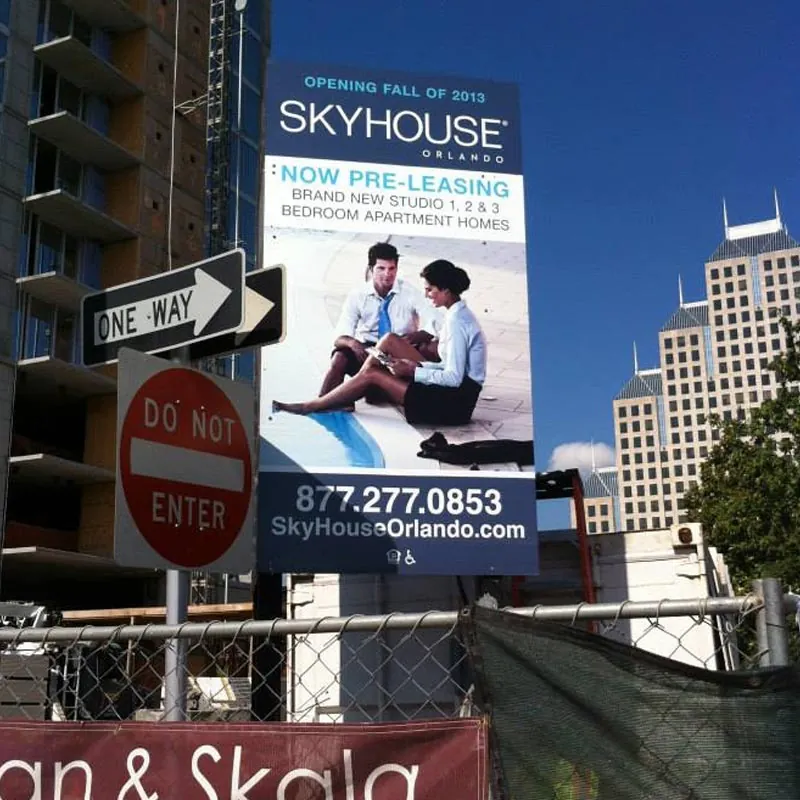 Tall pre-leasing construction site sign for a downtown Orlando apartment tower