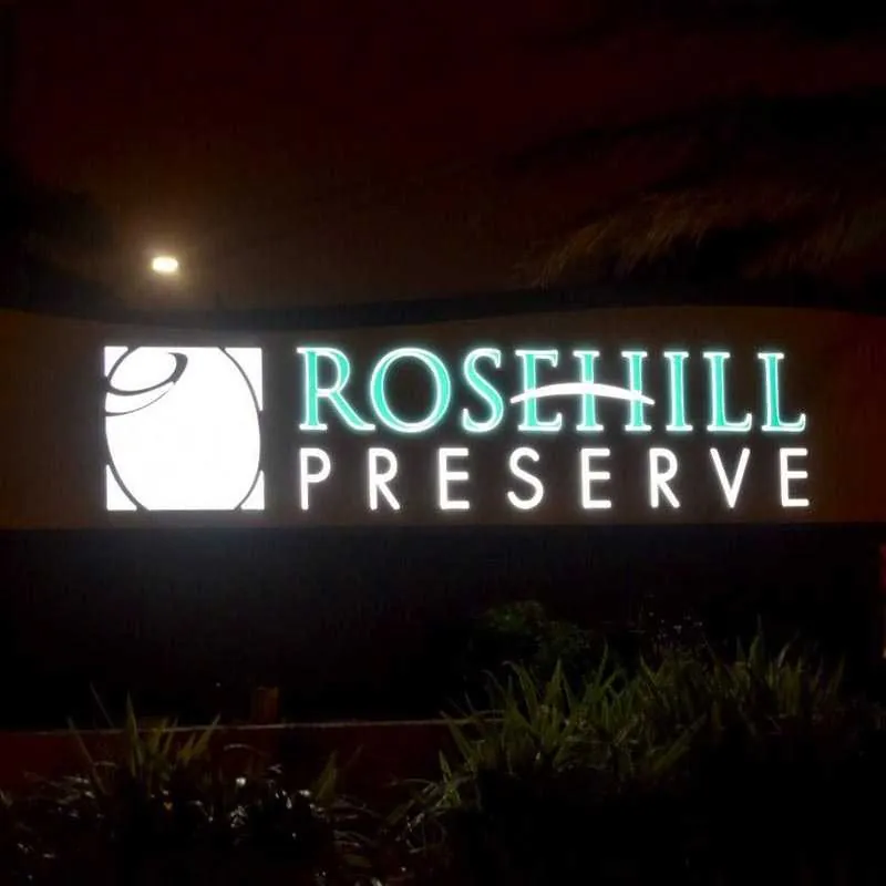 The same Rosehill Preserve sign illuminated at night